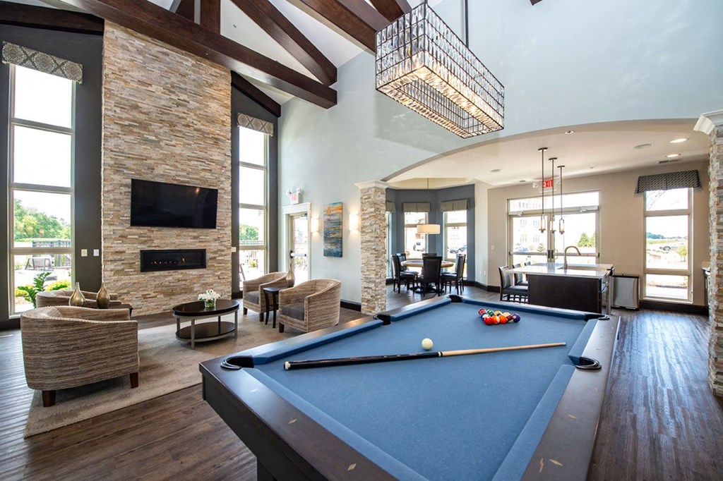 a game room with a pool table and a fireplace