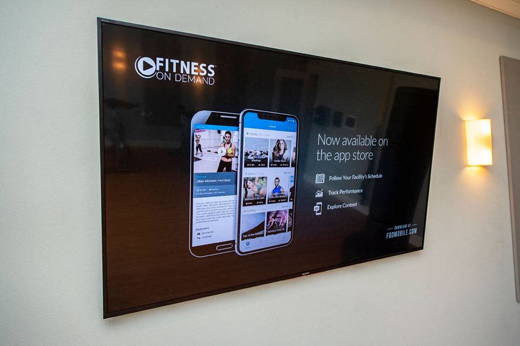 a large screen with a picture of two cell phones on a wall