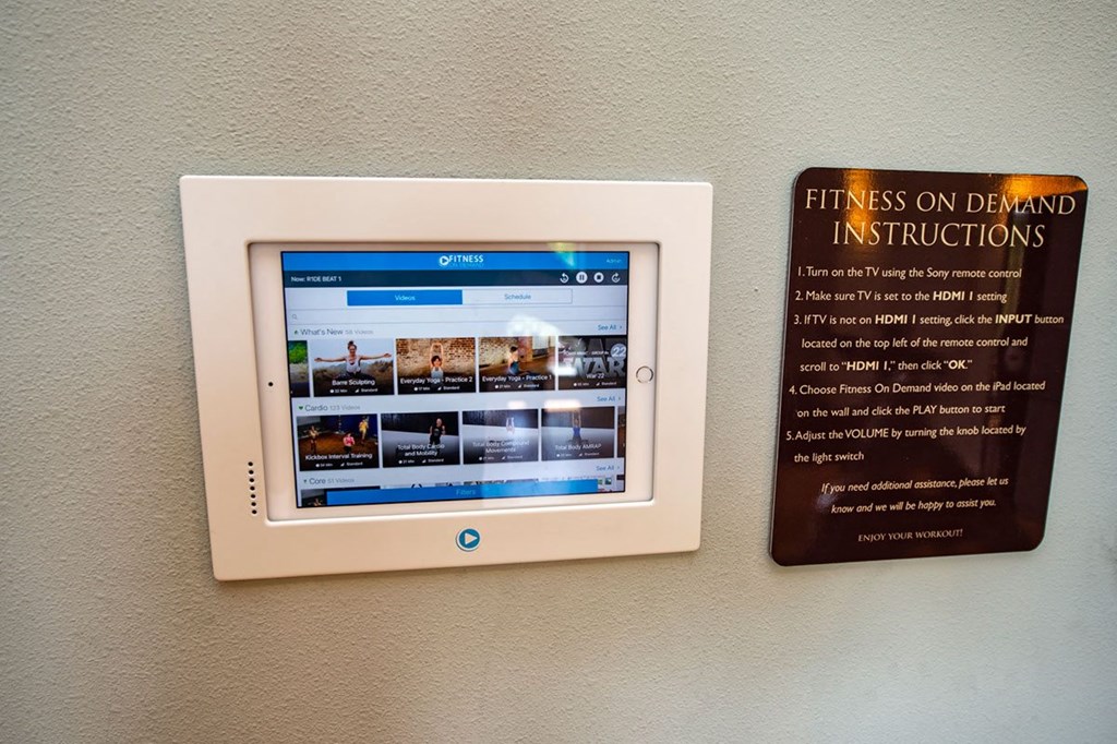 a tablet computer on a wall next to a sign