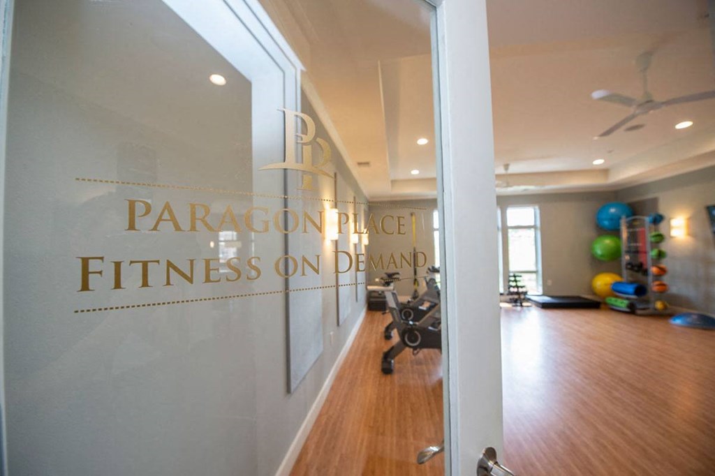 the entrance to a gym with a wall with a logo on it