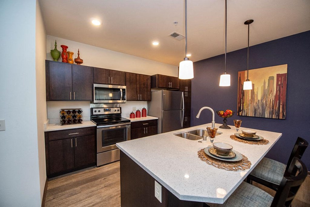 a kitchen with stainless steel appliances and a white counter top