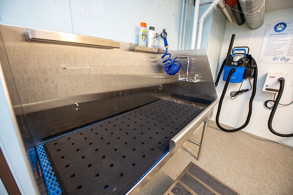 a stainless steel bench in a kitchen with a sink
