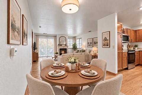 A dining room with a table set for a meal.
