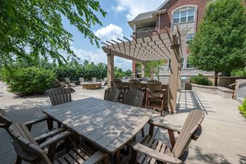 a patio with a table and chairs and a pergola