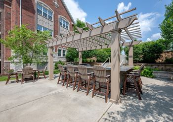 a patio with a table and chairs under a pergola