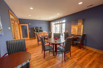a dining room with a table and chairs and a kitchen