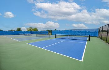 two tennis courts on a blue and green court