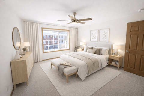 A bedroom with a large bed, a dresser, and a window with curtains.