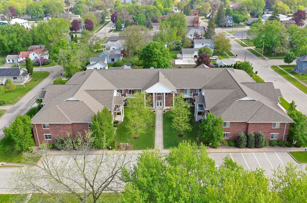 A large house with a driveway in front.