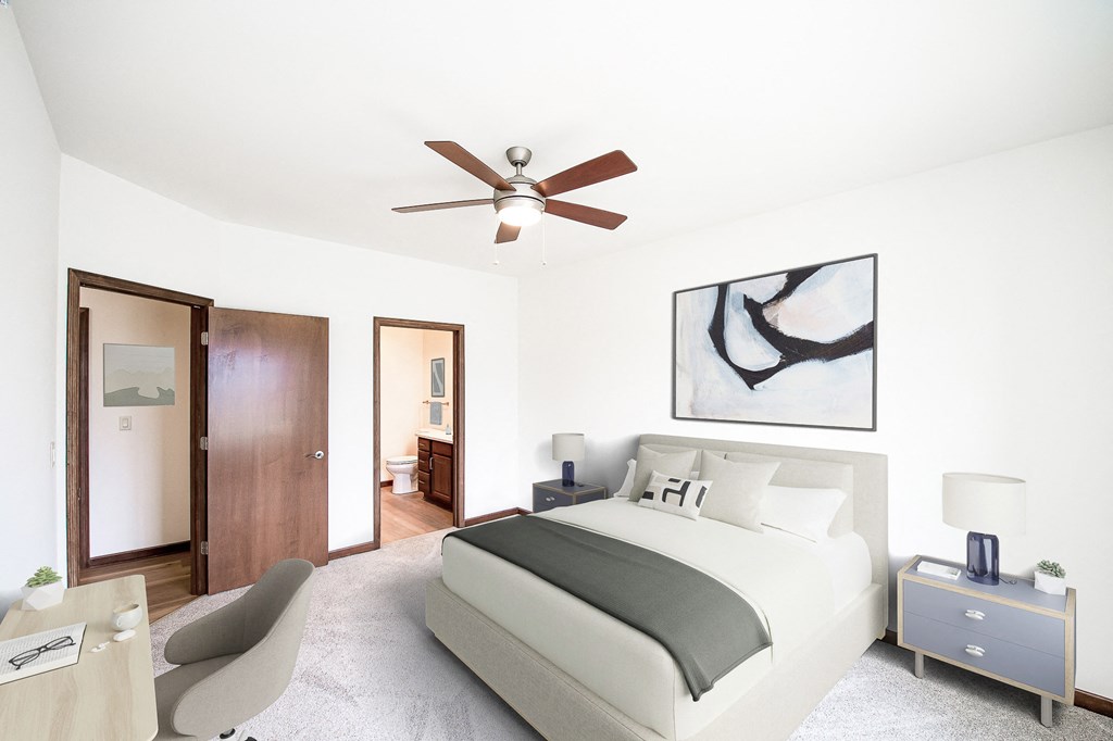 a bedroom with a large bed and a ceiling fan