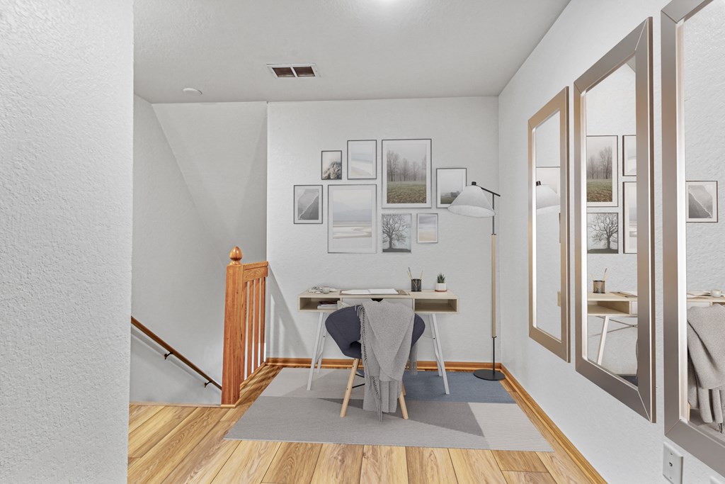 A dining room with a table and chairs.