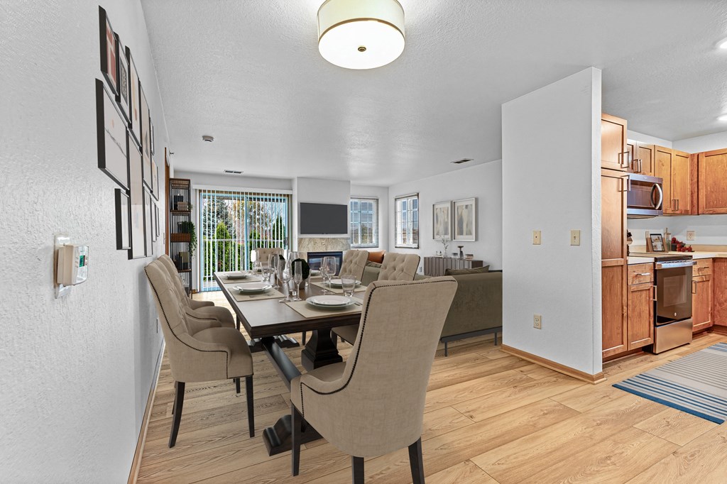 A modern dining room with a table set for four.