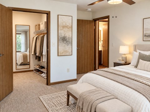A bedroom with a large bed and a mirrored closet.