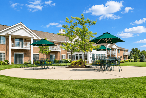 A large building with a green lawn in front.