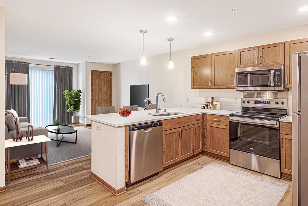 A modern kitchen with wooden cabinets and stainless steel appliances.