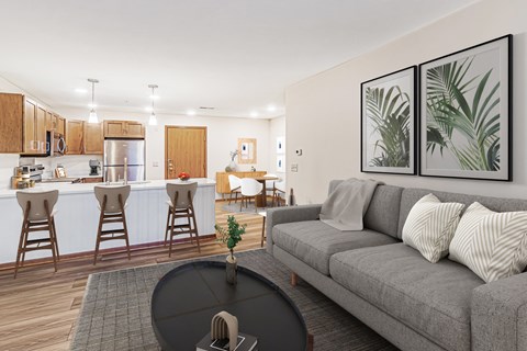 A living room with a grey couch and a black coffee table.