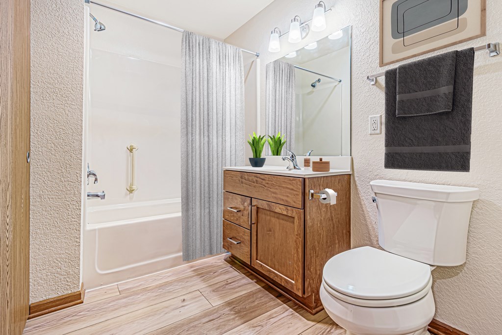 A bathroom with a toilet, sink, and bathtub.