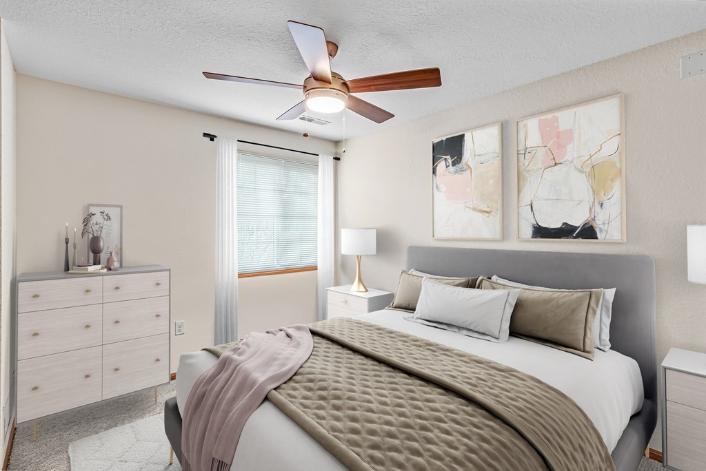 A bedroom with a bed, dresser, and ceiling fan.