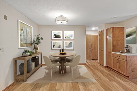 A dining room with a table set for four.