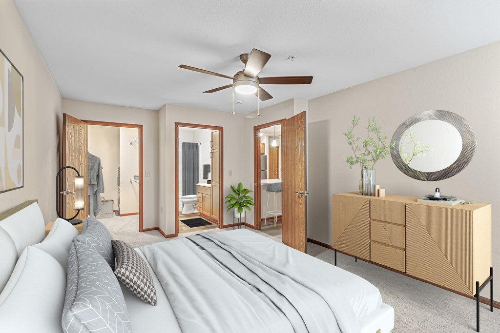 A bedroom with a large bed and a mirror on the wall.