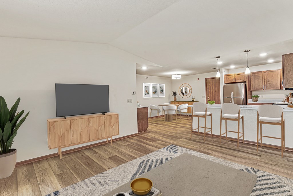 A living room with a television and a rug on the floor.