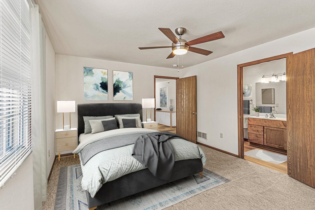 A bedroom with a bed, dresser, and mirror.