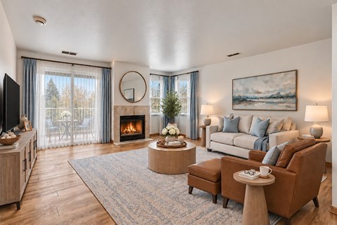 A living room with a fireplace and a painting on the wall.