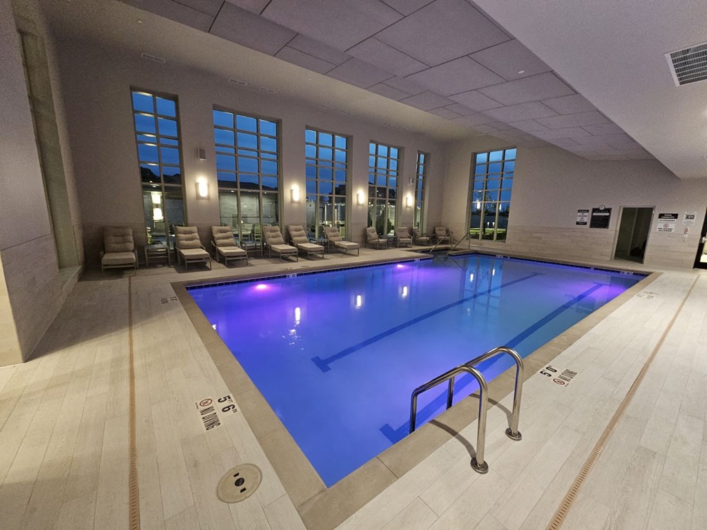 a swimming pool with blue lights in a large room
