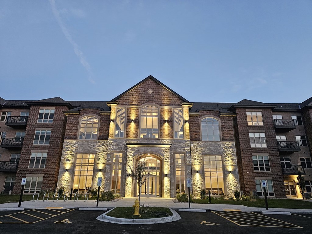 an exterior view of a building at night with lights on it