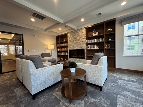 A living room with a grey carpet and a white sofa.