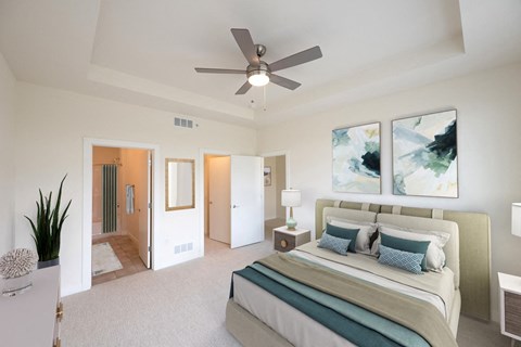 a bedroom with a large bed and a ceiling fan