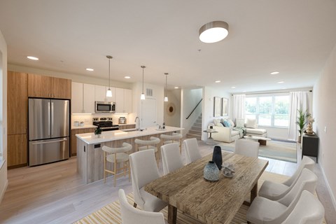 a kitchen and dining room with a table and chairs