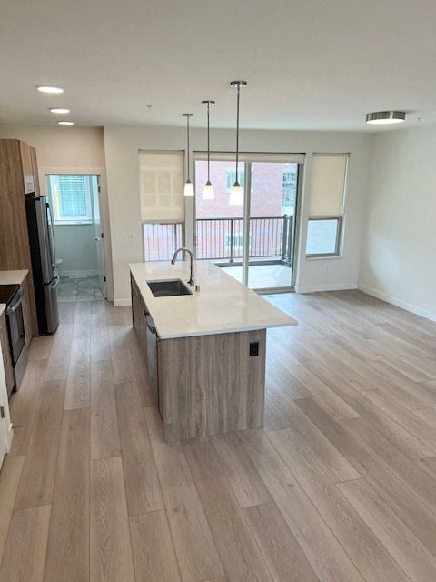 an empty kitchen and living room with a sink