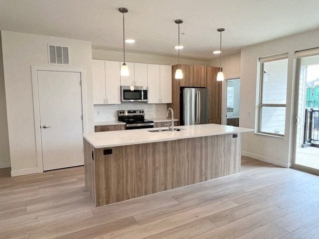 an empty kitchen with a large island in the middle