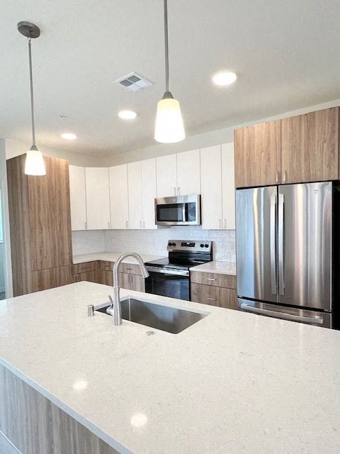 a kitchen with a sink and a refrigerator