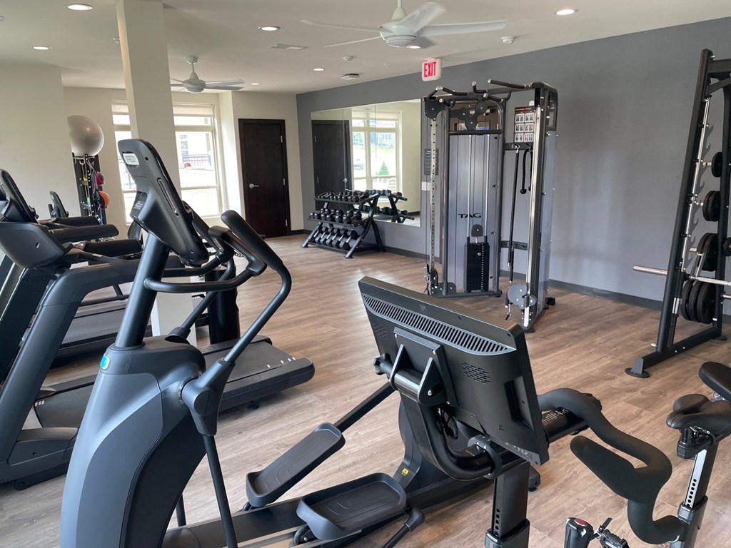 a gym with treadmills and other exercise equipment