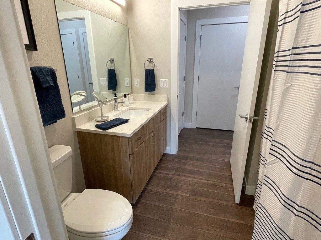 a bathroom with a toilet sink and shower