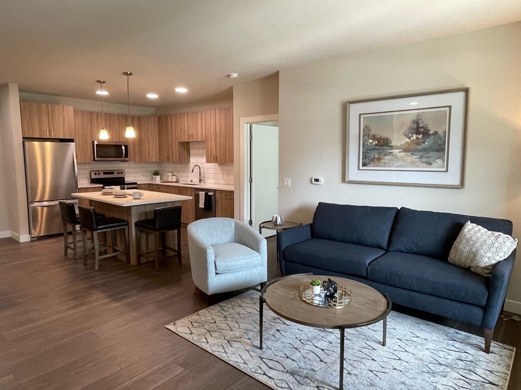 a living room with a couch a table and a chair