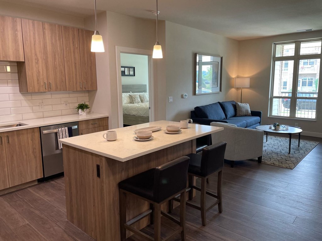 an open floor plan with a kitchen island and a living room with a couch and coffee table