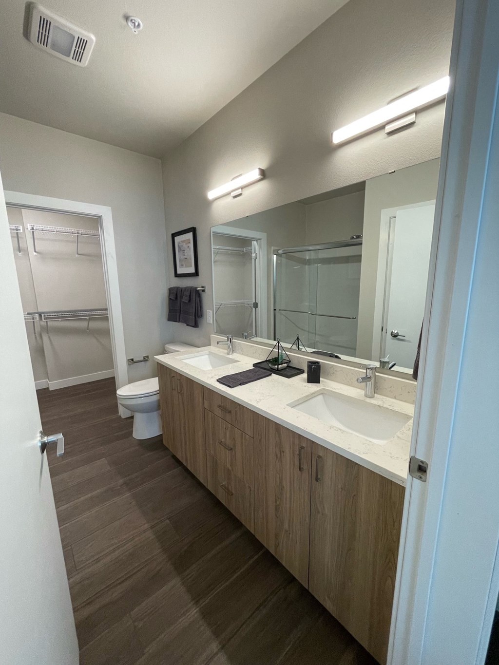 a large bathroom with two sinks and a toilet