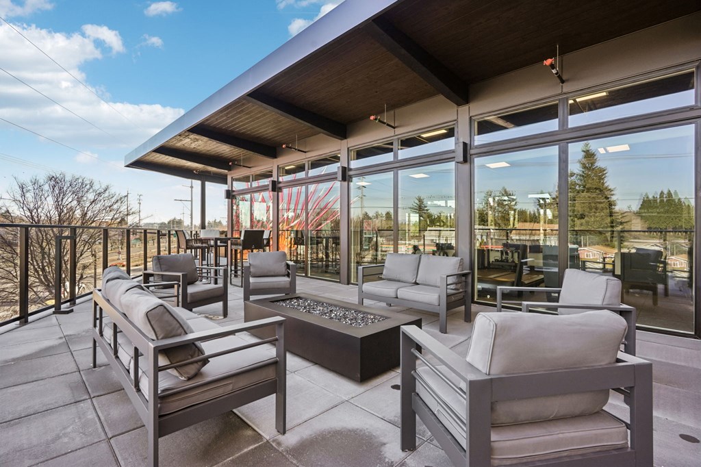 A patio with a table and chairs wood market hall view at AVIVA Apartments in Gresham Oregon