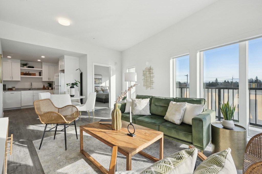 Living room and dining room with a couch and a table at AVIVA Apartments in Gresham Oregon