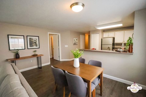 A dining room with a table and chairs.