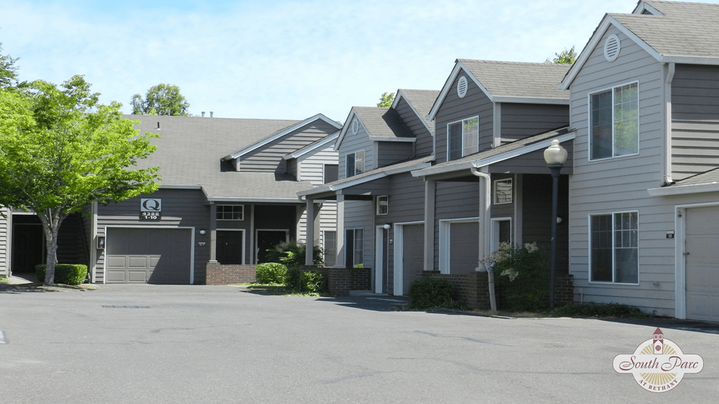 a row of houses with a parking lot