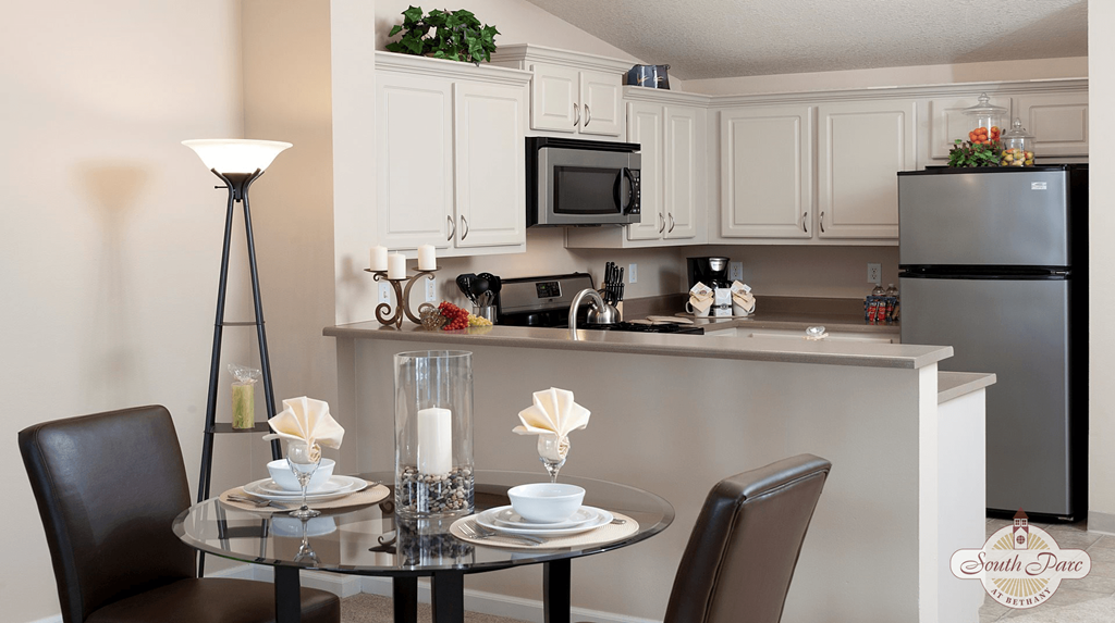 a kitchen and dining room with a table and chairs