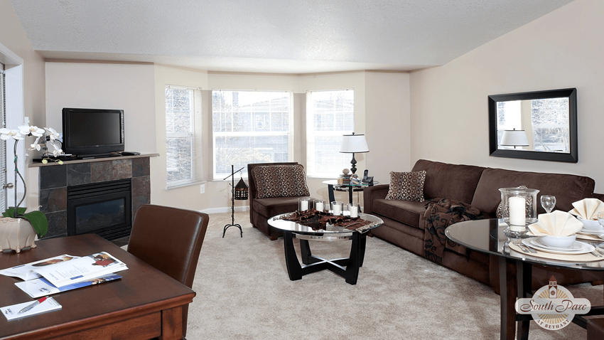 a living room with a couch and a table - Photo Gallery
