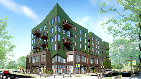 A modern building with a green roof and balconies is surrounded by trees and a street.