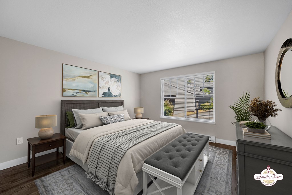 A bedroom with a large bed and a painting on the wall.