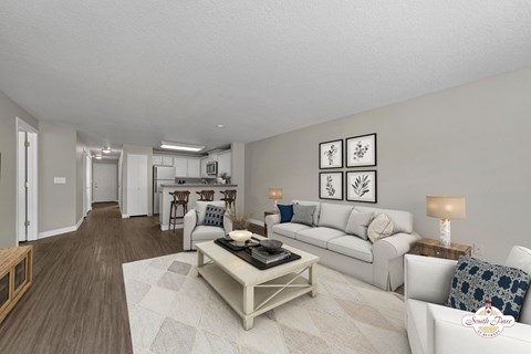 A living room with a white couch and a coffee table.