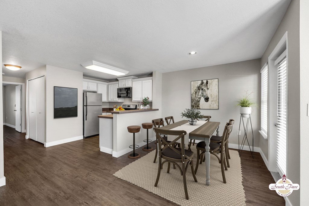 A modern kitchen with a dining table set for four.
